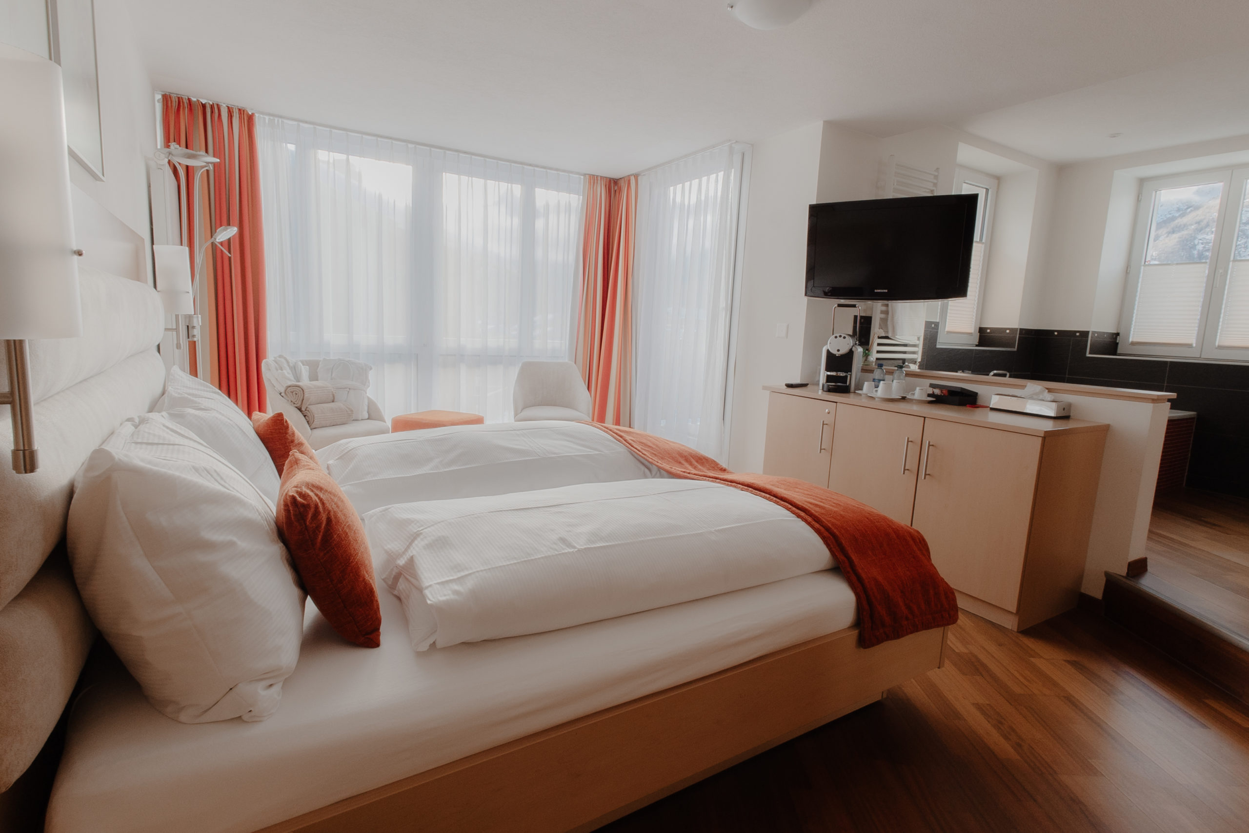 Elegant and spacious hotel room at Hotel Grächerhof, perfect for a Swiss Alps getaway