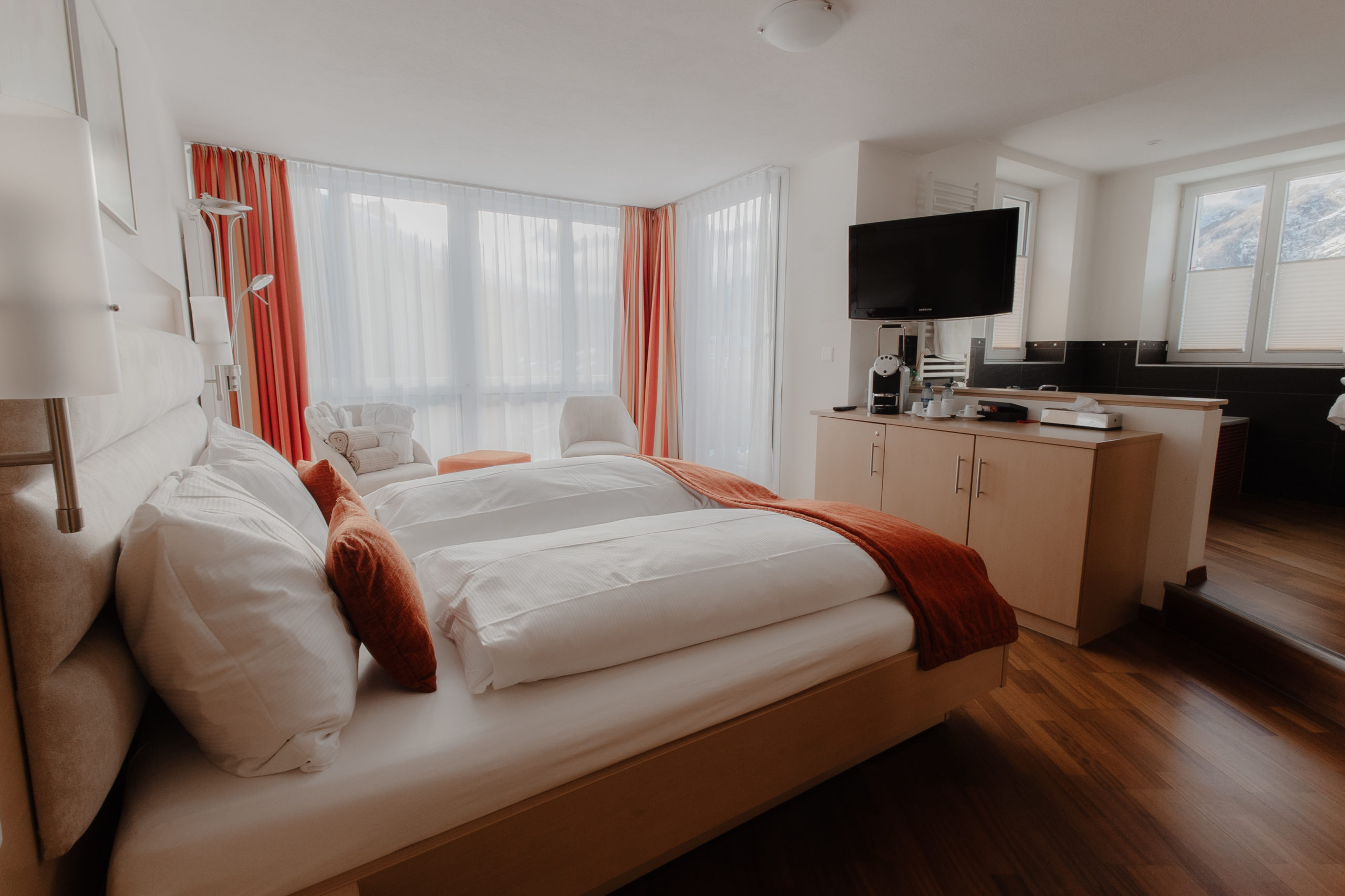 Elegant and spacious hotel room at Hotel Grächerhof, perfect for a Swiss Alps getaway