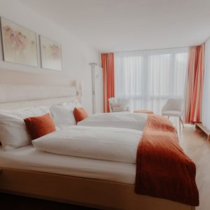 Elegant and spacious hotel room at Hotel Grächerhof, perfect for a Swiss Alps getaway