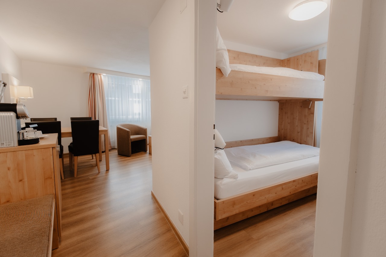 Elegant and spacious hotel room at Hotel Grächerhof, perfect for a Swiss Alps getaway