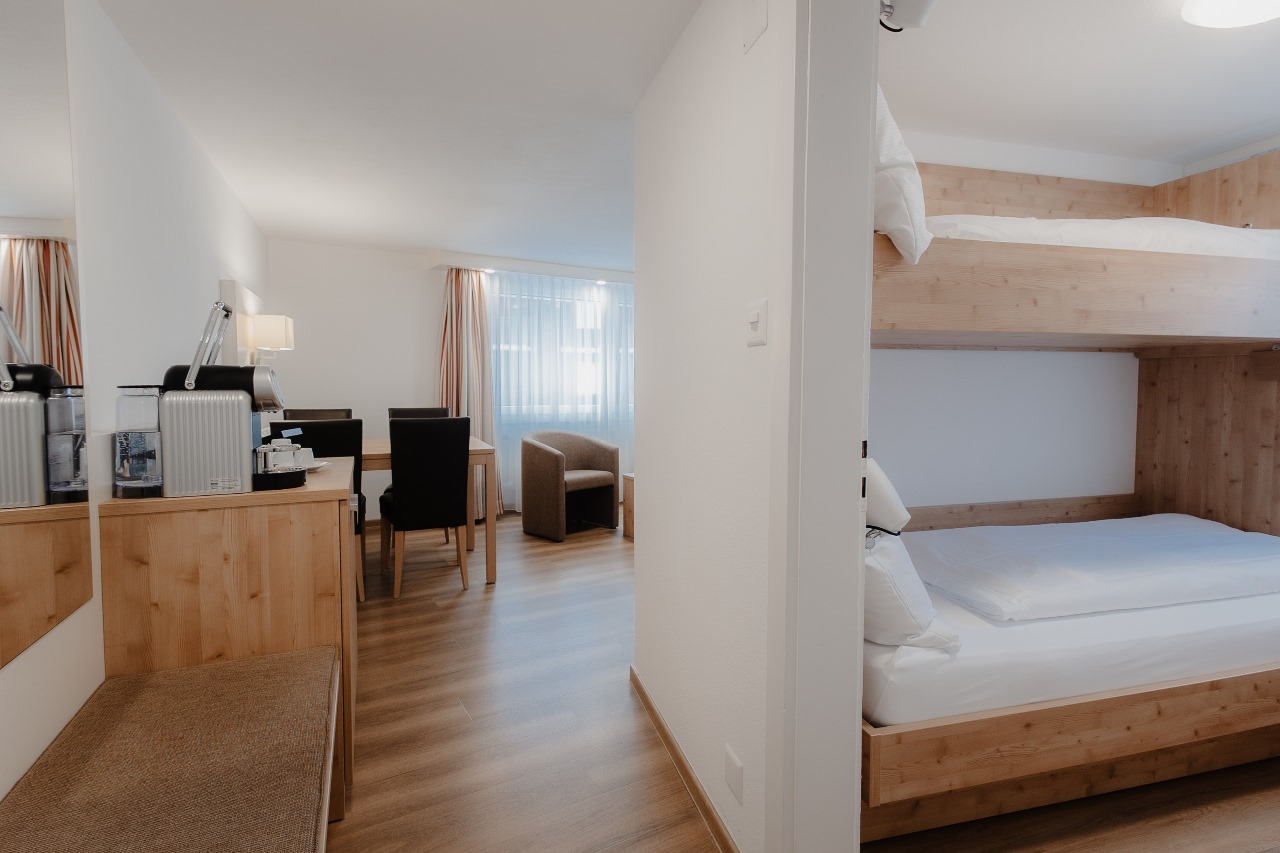 Elegant and spacious hotel room at Hotel Grächerhof, perfect for a Swiss Alps getaway