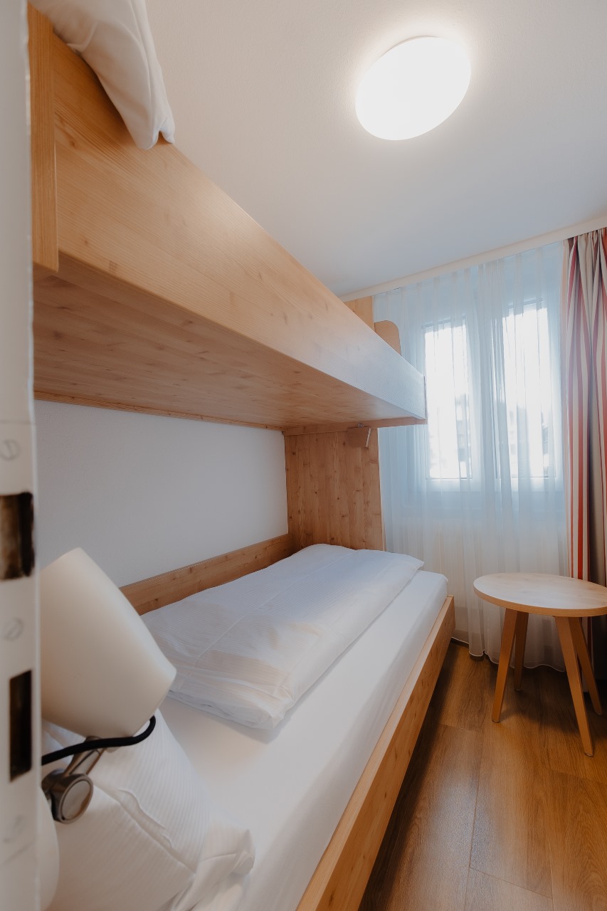 Elegant and spacious hotel room at Hotel Grächerhof, perfect for a Swiss Alps getaway