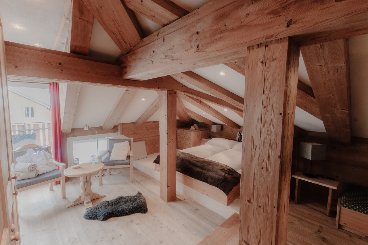 Elegant and spacious hotel room at Hotel Grächerhof, perfect for a Swiss Alps getaway