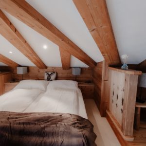 Elegant and spacious hotel room at Hotel Grächerhof, perfect for a Swiss Alps getaway