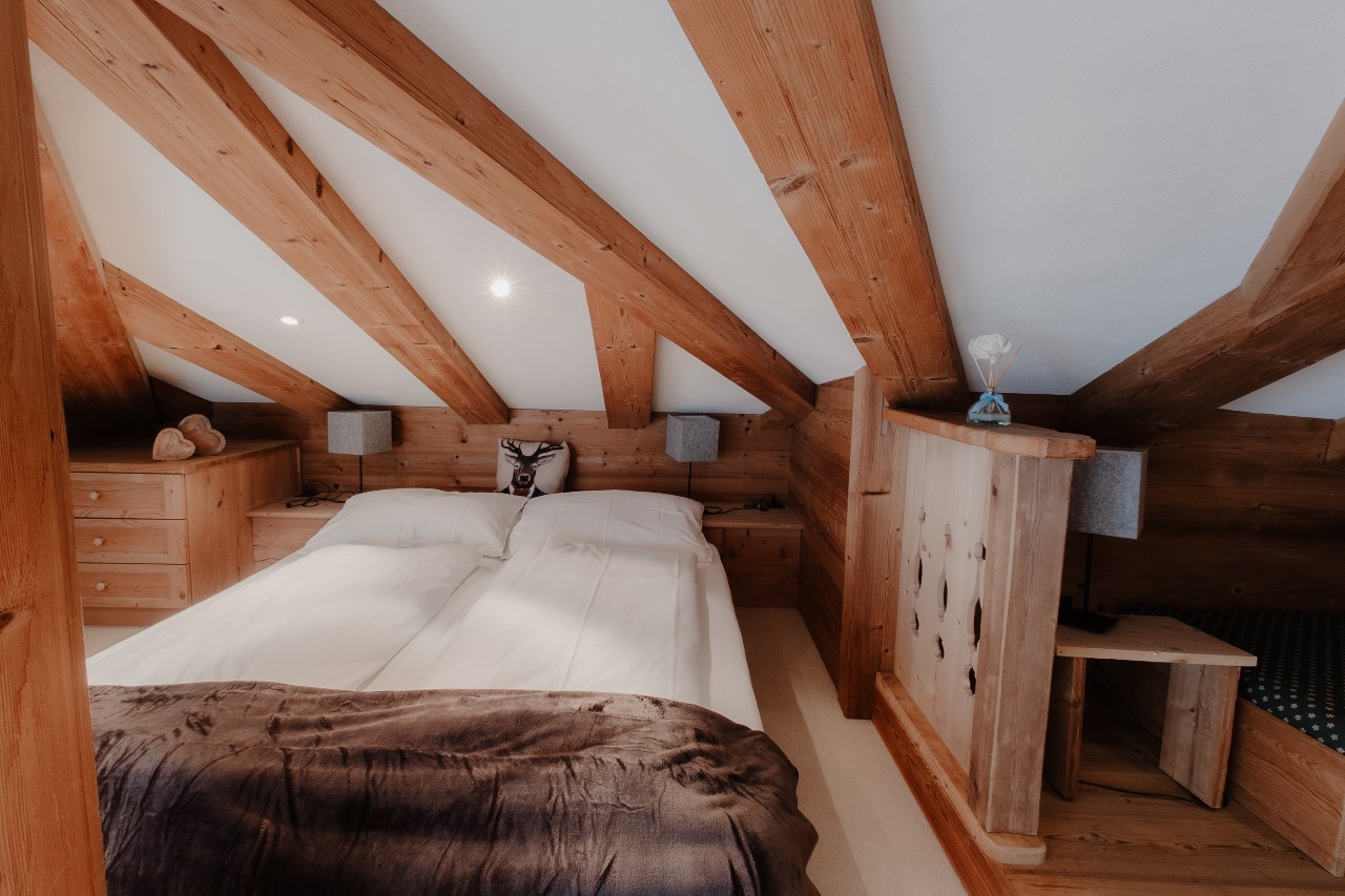 Elegant and spacious hotel room at Hotel Grächerhof, perfect for a Swiss Alps getaway