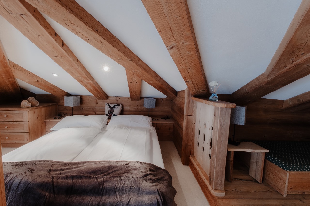 Elegant and spacious hotel room at Hotel Grächerhof, perfect for a Swiss Alps getaway